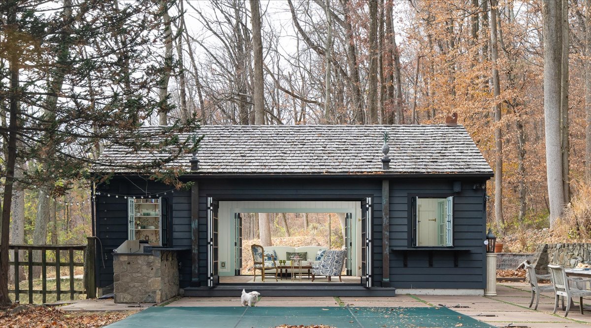 Exterior view of the Crow's Perch pool house with open doors facing the pool