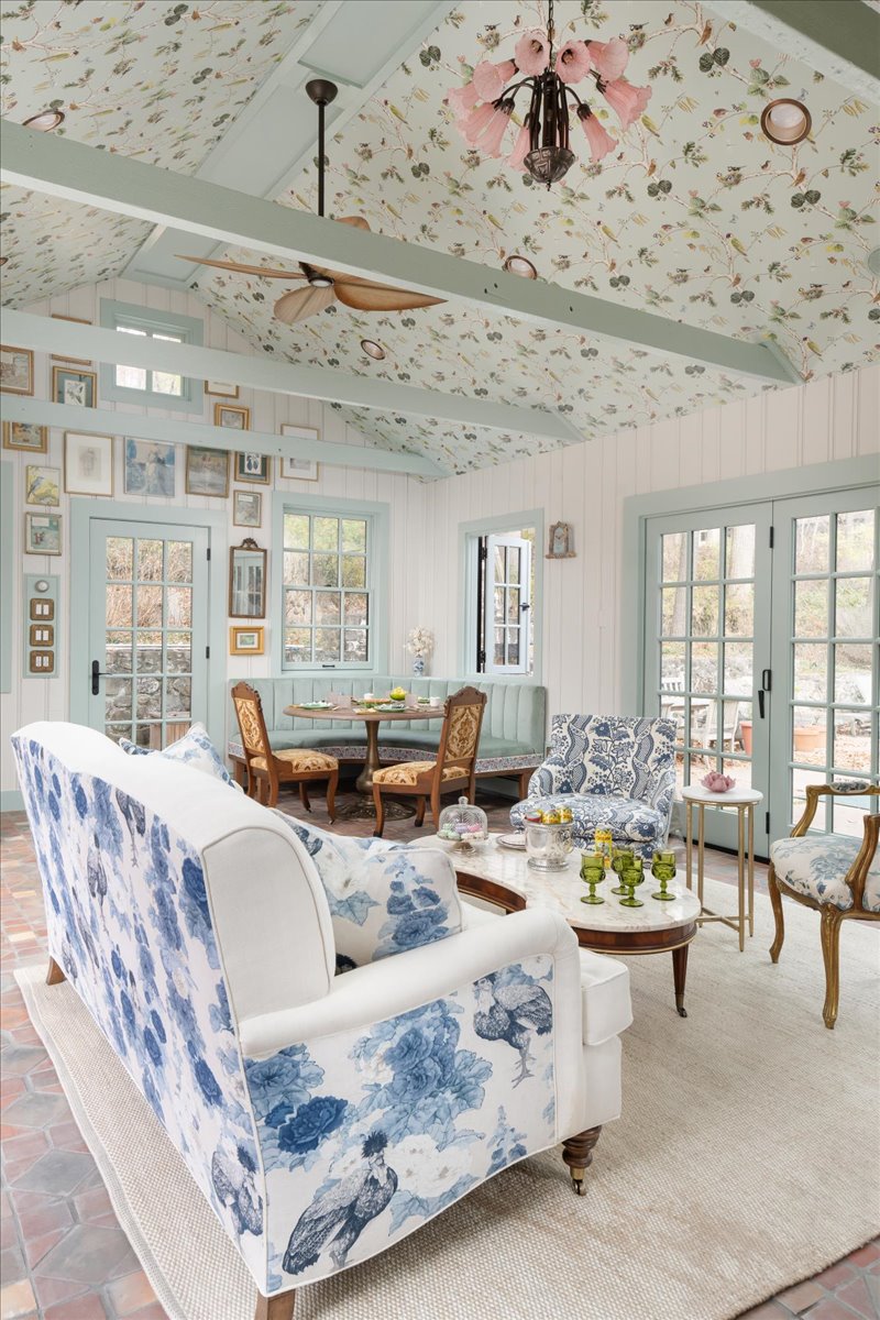 Patterned upholstered chair and white sofa in the pool house