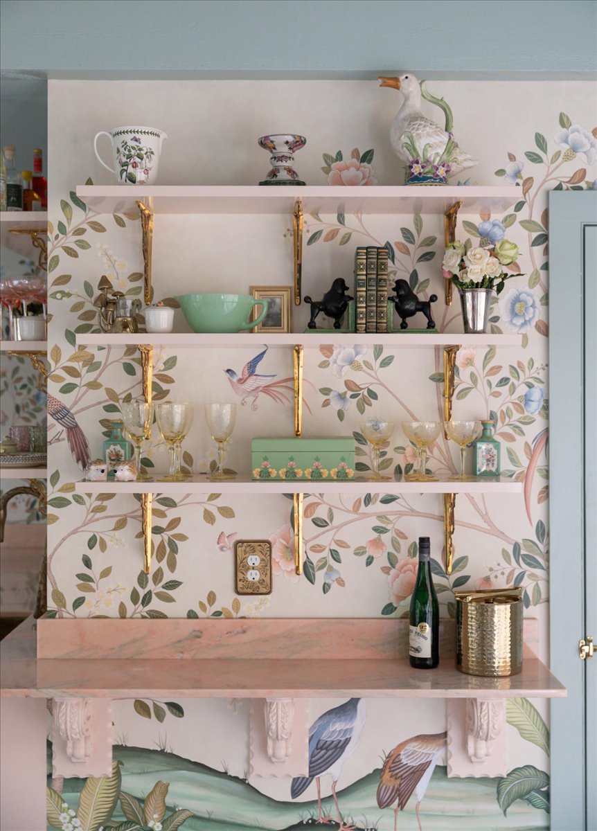 Kitchenette open shelving with patterned wallpaper and decorative glassware