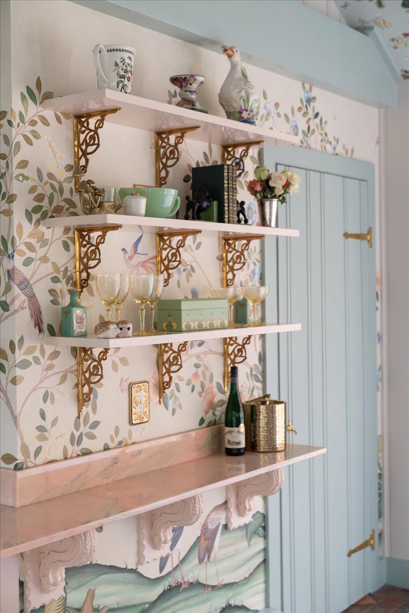 Kitchenette shelves, brass brackets, marble counter, and patterned wallcovering