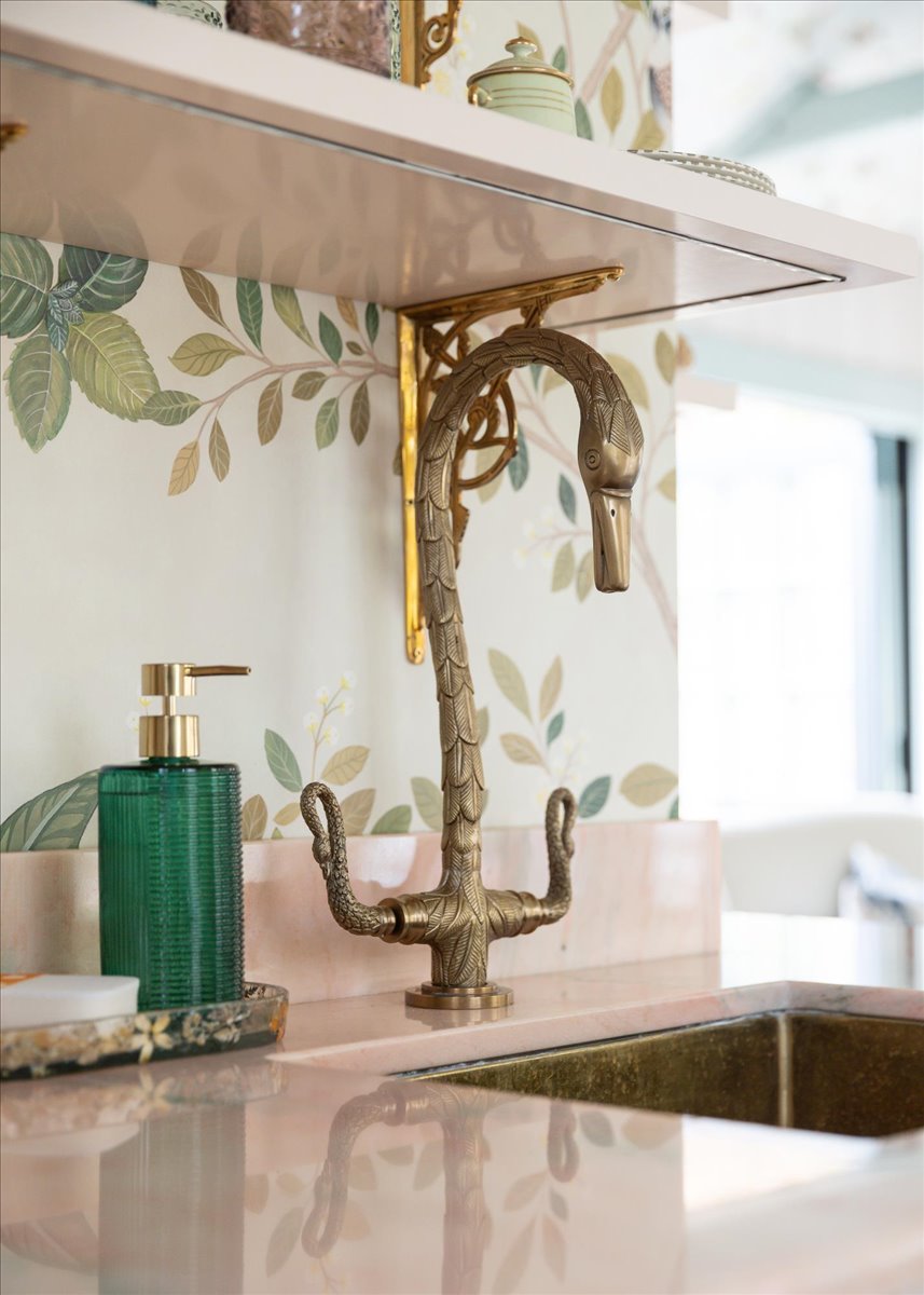 Custom brass swan faucet at the kitchenette sink