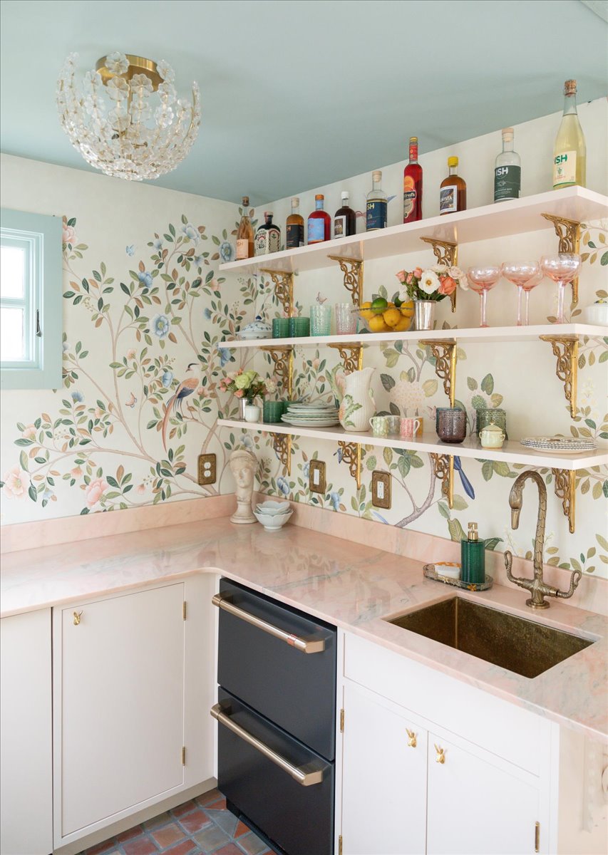 Redesigned kitchenette with open shelves, cabinetry, and patterned walls