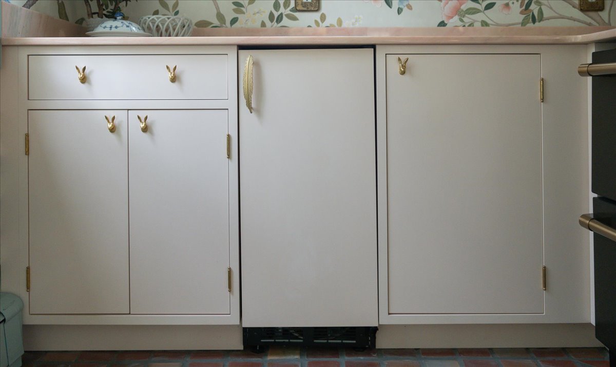 Custom cabinetry with concealed storage below a patterned wall