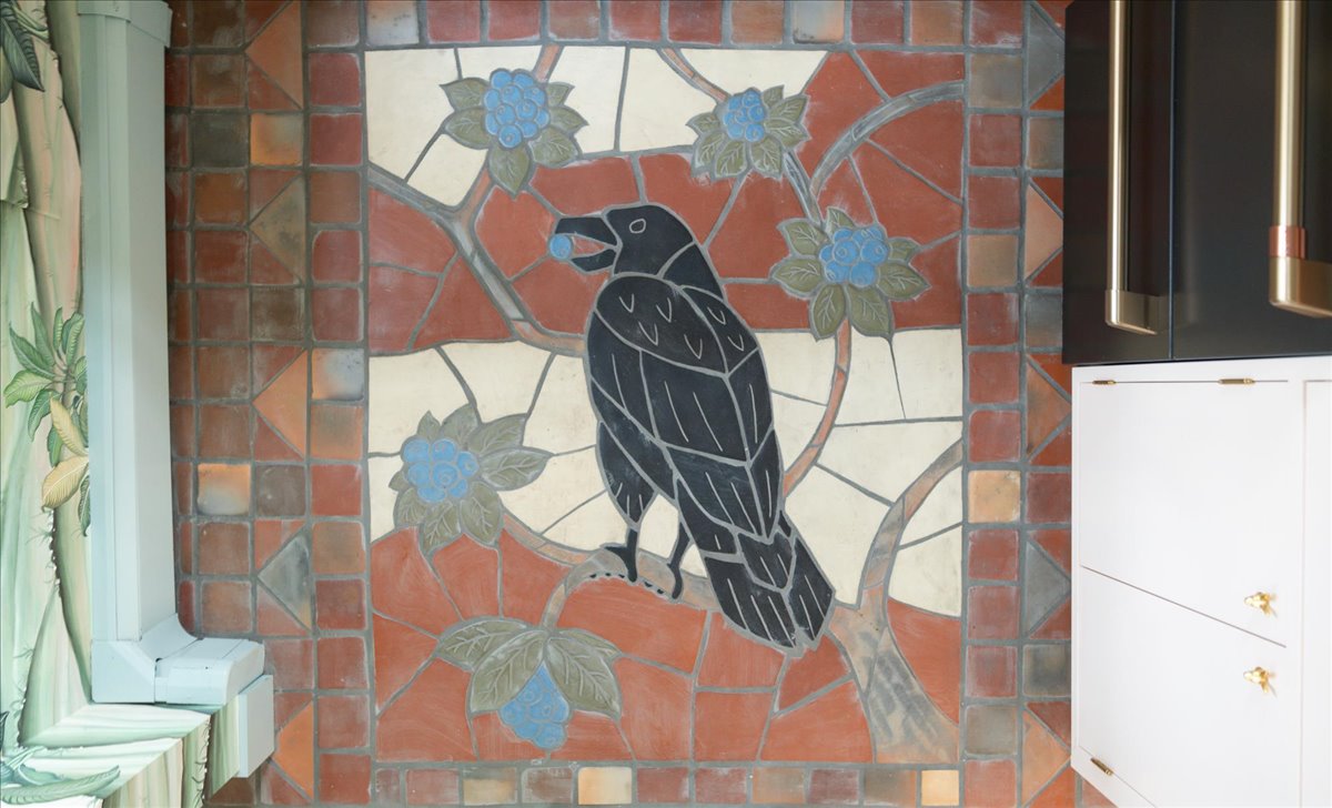 Locally sourced tile floor with a crow design