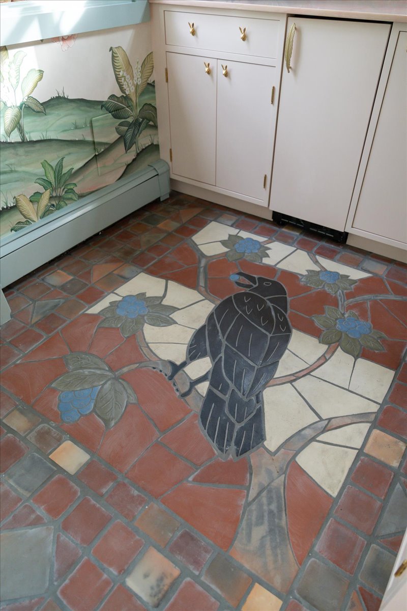 Crow mural inset within patterned tile flooring
