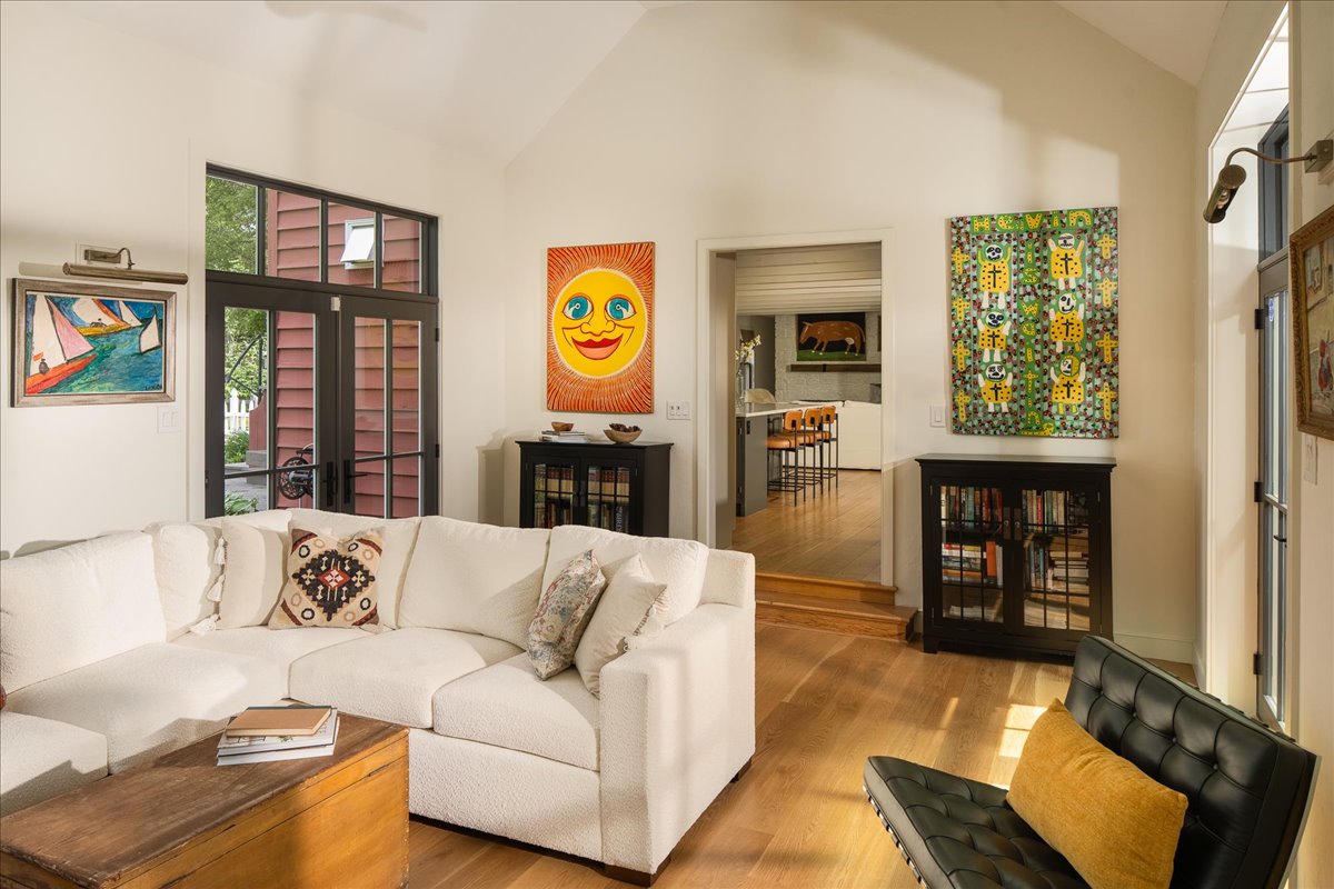 Open Gallery House living and dining space with custom fireplace and layered materials