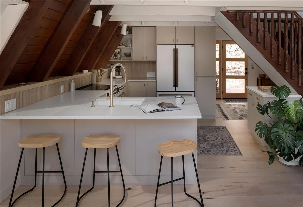 A-frame living room with wood ceiling and fireplace